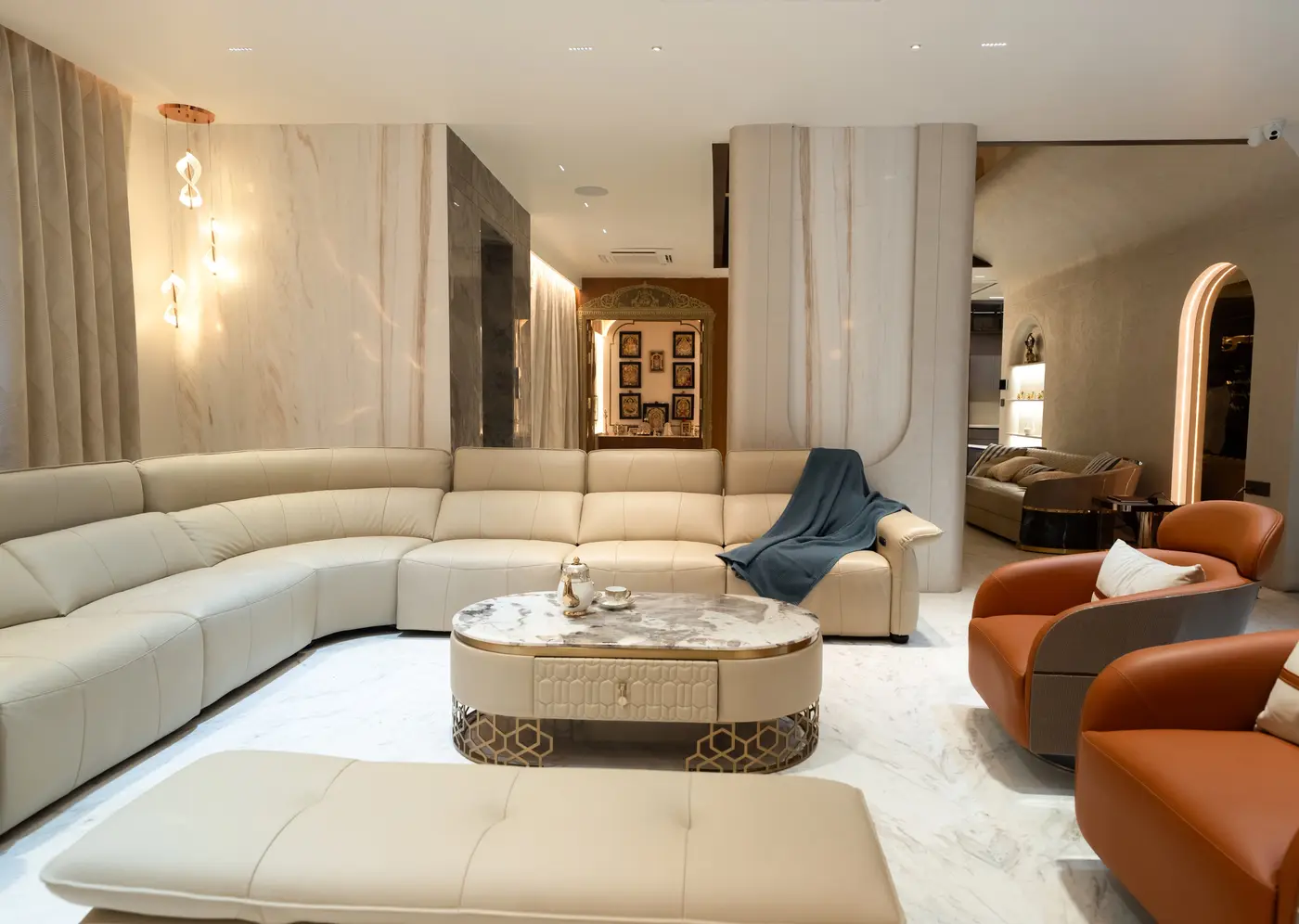 Curved sectional sofa with an oval coffee table and accent chairs, with clear walking space around them