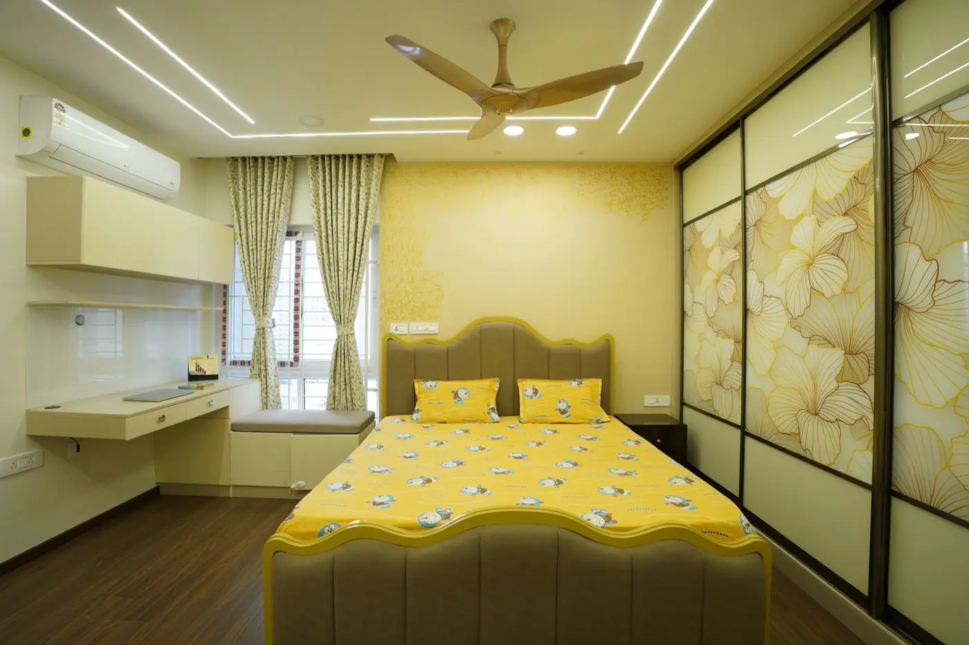 Bedroom with a printed sliding wardrobe wall, dressing unit with oval mirror and cove lighting